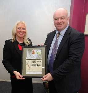IOMPO Chairman Julie Edge MHK presenting Chief Minister Howard Quayle MHK with a framed set of stamps