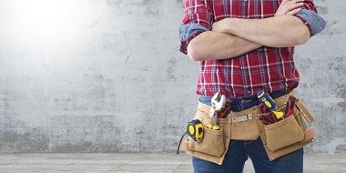 Man posing with builder belt and tools in it