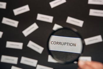 Magnifying lens on the word corruption