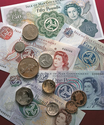 Manx notes and coins scattered over table