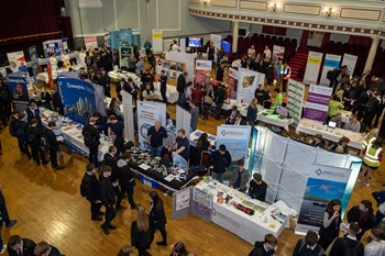 Arial view of the Employment and Skills fair which shows various company stands surrounded by students who are looking into their next steps after education