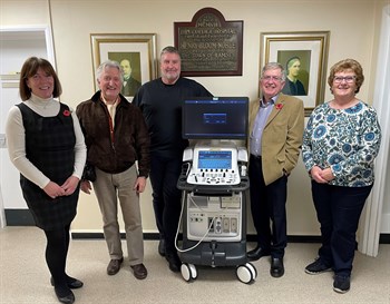 Trustees of the RDCH Welfare Fund and the RDCH Endowment Trustees standing in front of a plaque at RDCH. They are standing next to a new echo machine recently supplied to RDCH