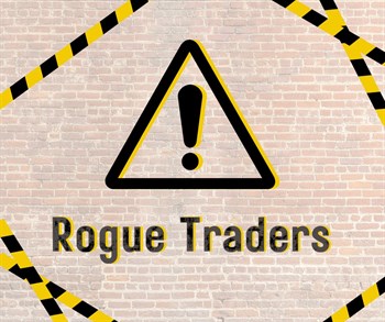 Wall background with black warning sign with yellow highlights, black and yellow tab are going across the cornors with the text rough traders under the warning sign
