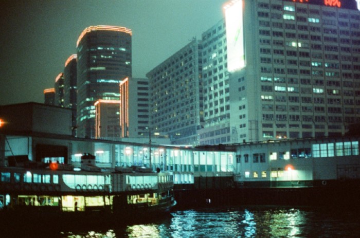 Ferry terminal at night, with skyscrapers around it